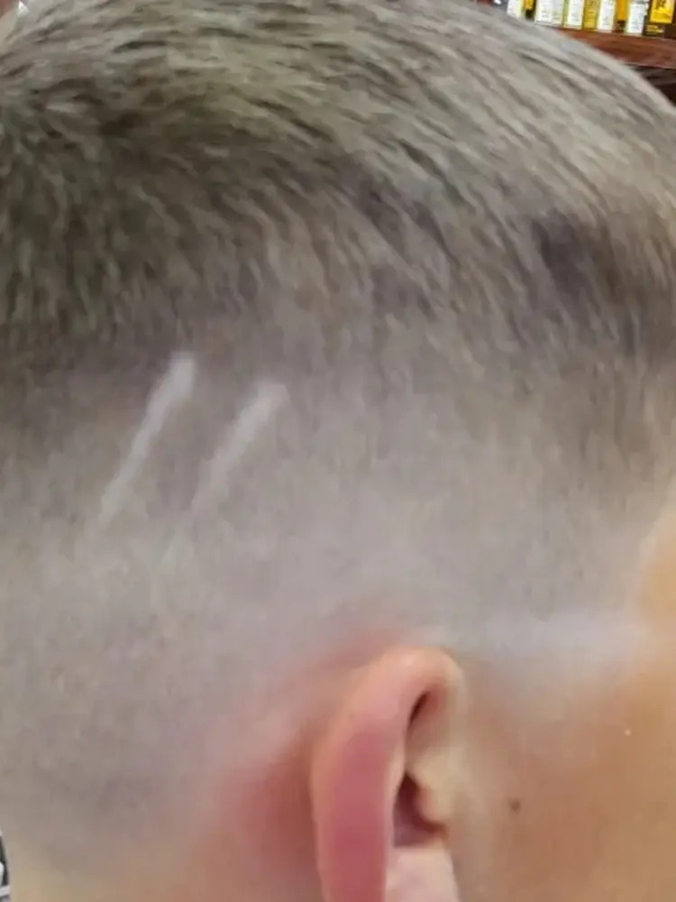 Back of a client's head showing a sharp faded crop